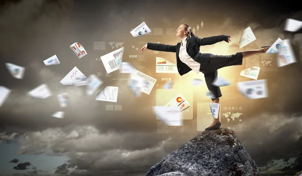 Businesswoman standing atop of mountain — Stock Photo, Image