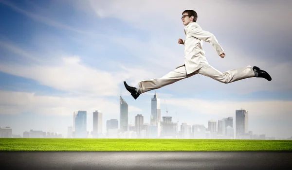 Businessman running on the road — Stock Photo, Image