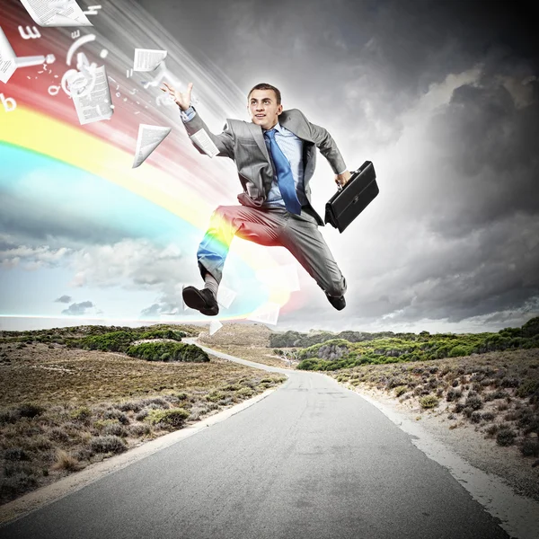 Businessman running on the road — Stock Photo, Image