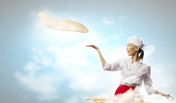 Азиатская кухарка делает пиццу — стоковое фото