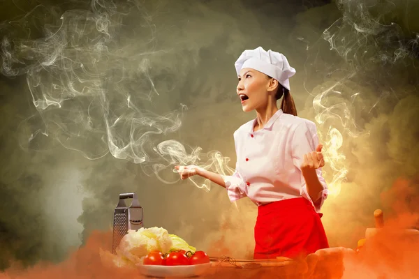 Asian female cook in anger — Stock Photo, Image