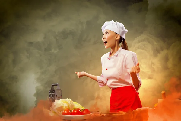 Asian female cook in anger — Stock Photo, Image