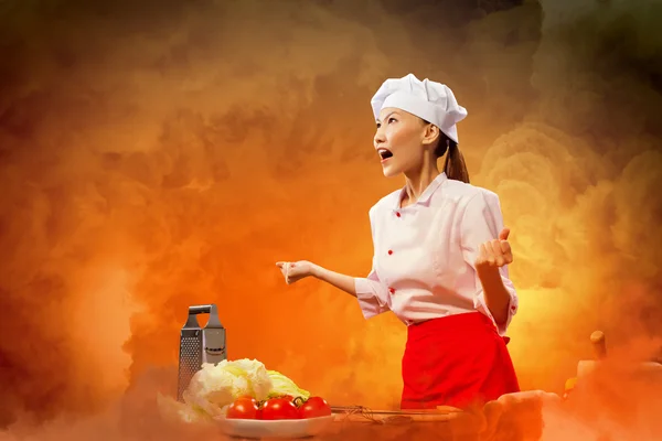 Asian female cook in anger — Stock Photo, Image