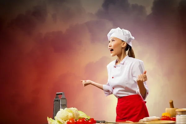 Asian female cook in anger — Stock Photo, Image