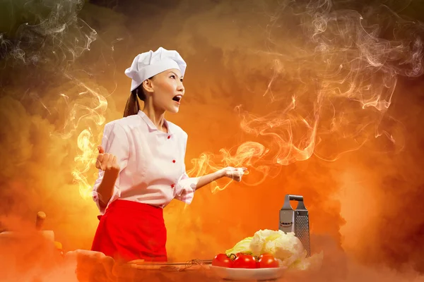 Asian female cook in anger — Stock Photo, Image