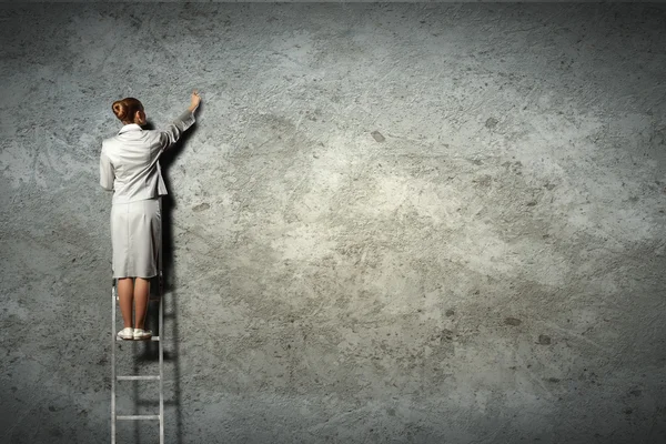 Diagramas de dibujo de mujer de negocios en la pared — Foto de Stock