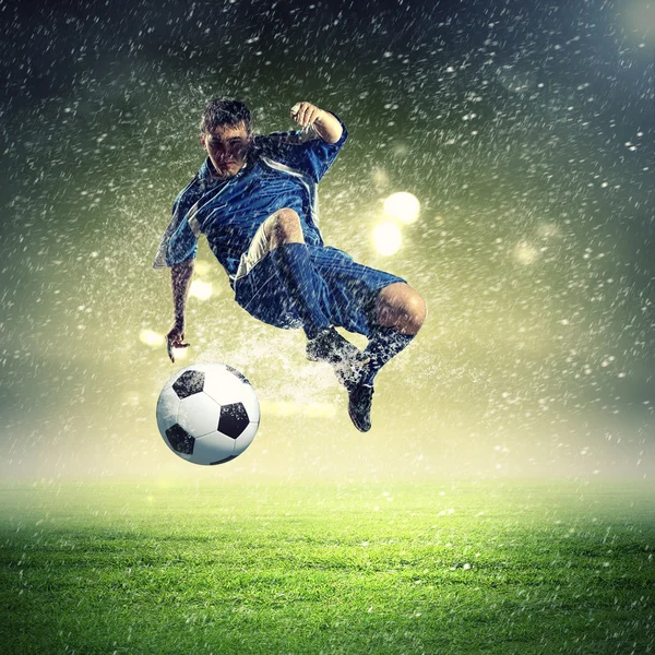 Joueur de football frappant le ballon — Photo