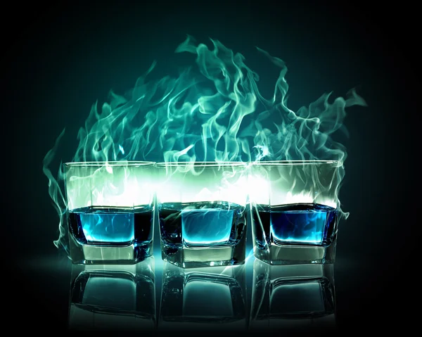 Three glasses of burning emerald absinthe — Stock Photo, Image