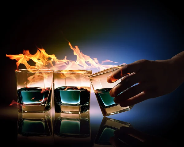 Three glasses of burning emerald absinthe — Stock Photo, Image