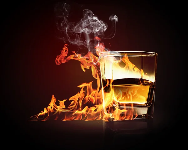 Glass of burning yellow absinthe — Stock Photo, Image