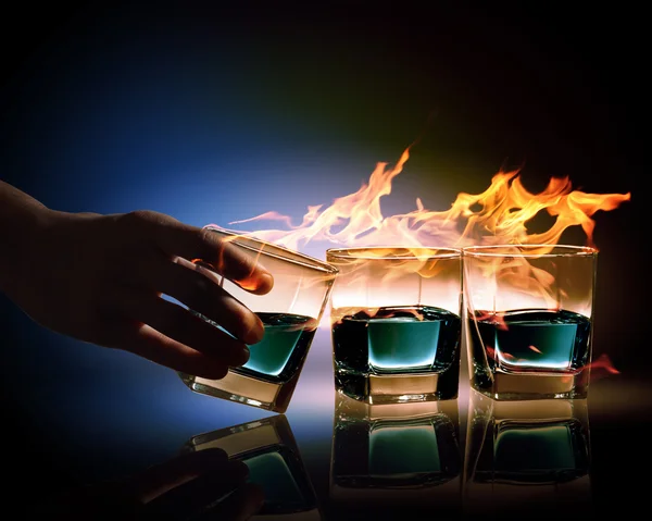 Three glasses of burning emerald absinthe — Stock Photo, Image