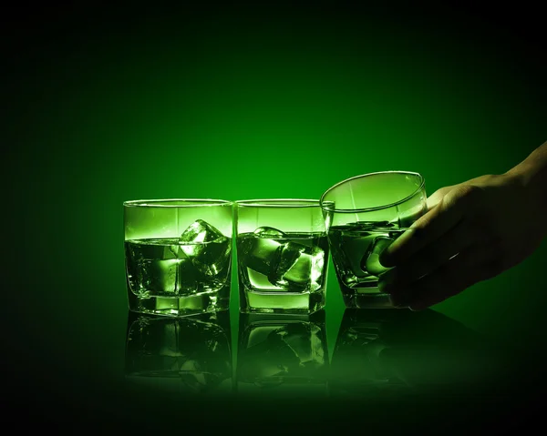 Three glasses of green absinth with ice cubes — Stock Photo, Image