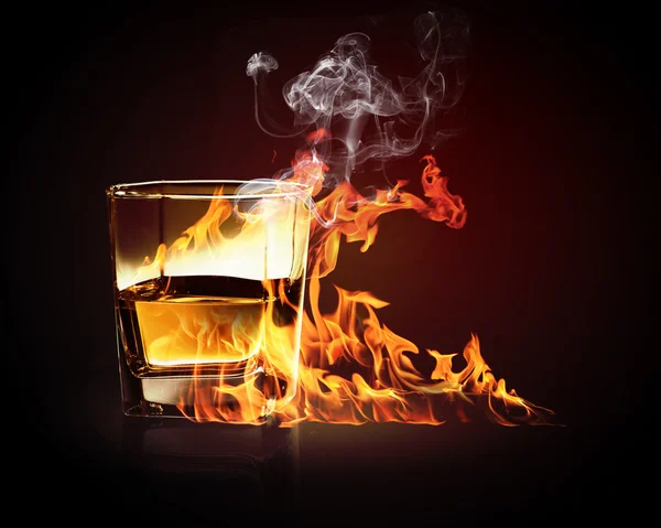 Glass of burning yellow absinthe — Stock Photo, Image