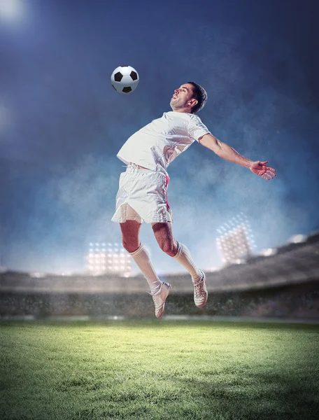 Football player striking the ball Stock Photo