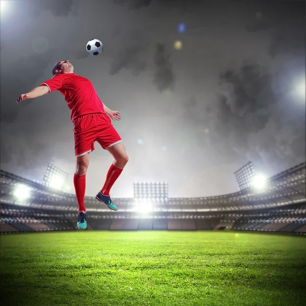 Football player striking the ball Stock Photo