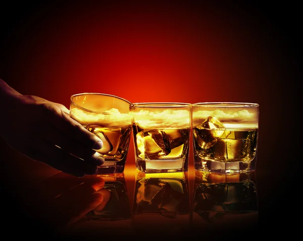 Three glasses of whiskey with ice cubes — Stock Photo, Image
