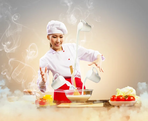 Asian female cooking with magic — Stock Photo, Image