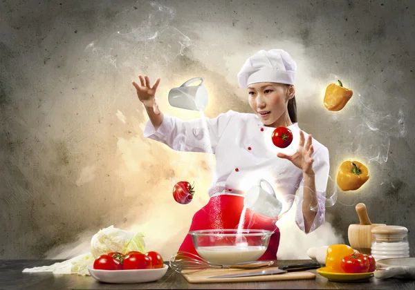 Asian female cooking with magic — Stock Photo, Image