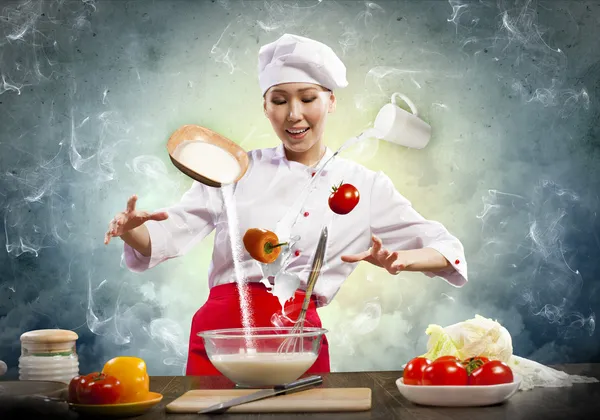 Asian female cooking with magic — Stock Photo, Image