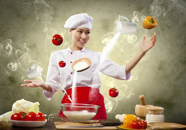 Asian female cooking with magic — Stock Photo, Image