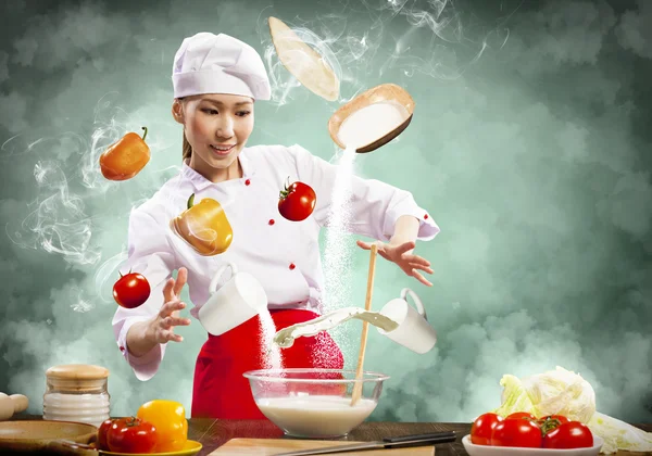 Asian female cooking with magic — Stock Photo, Image