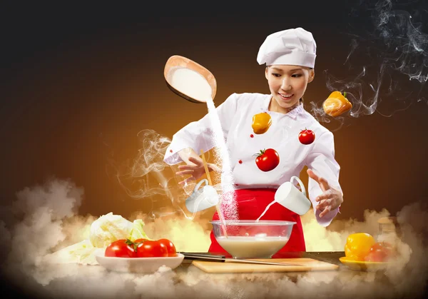 Asian female cooking with magic — Stock Photo, Image