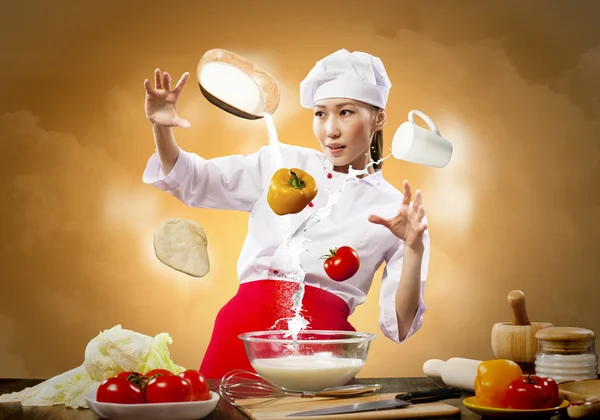 Asian female cooking with magic — Stock Photo, Image