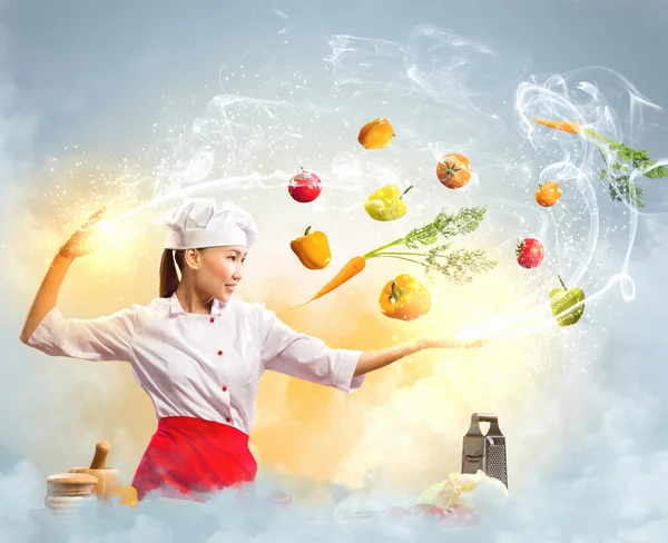 Asian female cooking with magic — Stock Photo, Image