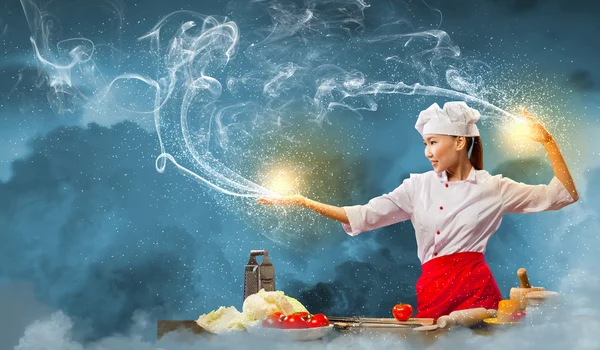 Asian female cooking with magic — Stock Photo, Image