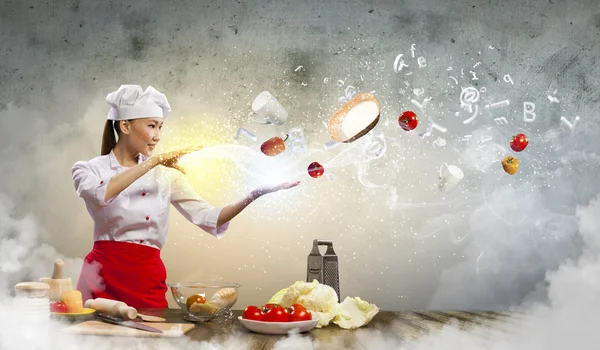 Asian female cooking with magic — Stock Photo, Image