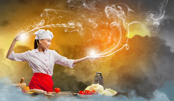 Asiatico femmina cucina con magia — Foto Stock