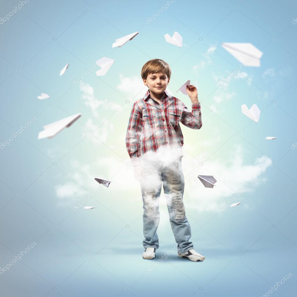 Little boy playing with paper plane