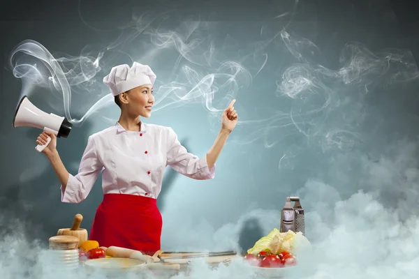 Asian female cook holding megaphone — Stock Photo, Image