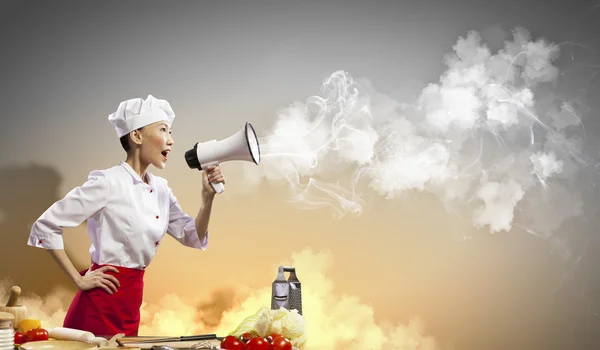 Asian female cook holding megaphone — Stock Photo, Image