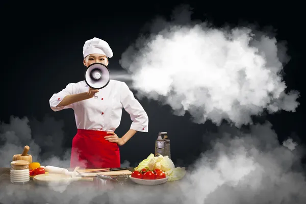 Asian female cook holding megaphone — Stock Photo, Image