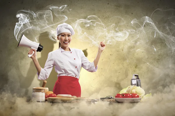 Asian female cook holding megaphone — Stock Photo, Image