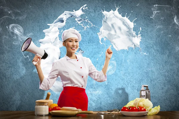 Asian female cook holding megaphone — Stock Photo, Image