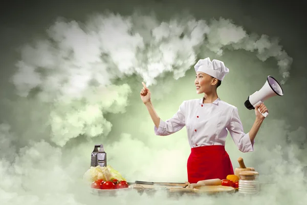 Asian female cook holding megaphone — Stock Photo, Image