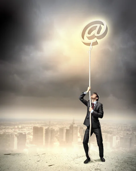 Image of businessman climbing rope — Stock Photo, Image