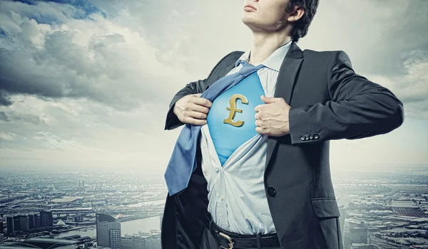 Businessman showing superman suit underneath shirt — Stock Photo, Image