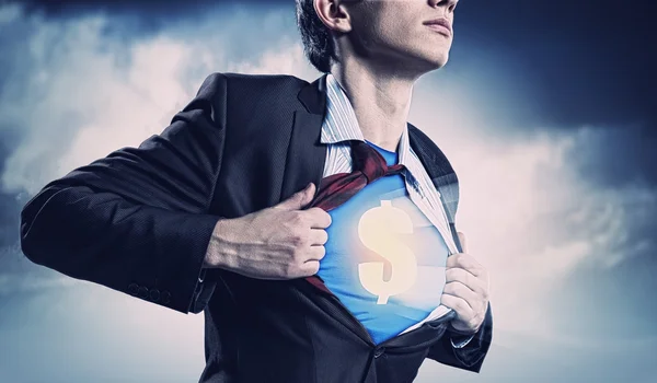 Businessman showing superman suit underneath shirt — Stock Photo, Image