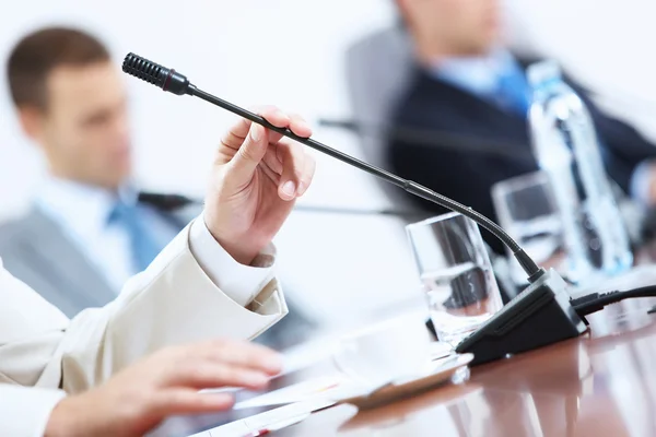 Hands of businessman holding microphone — Stock Photo, Image