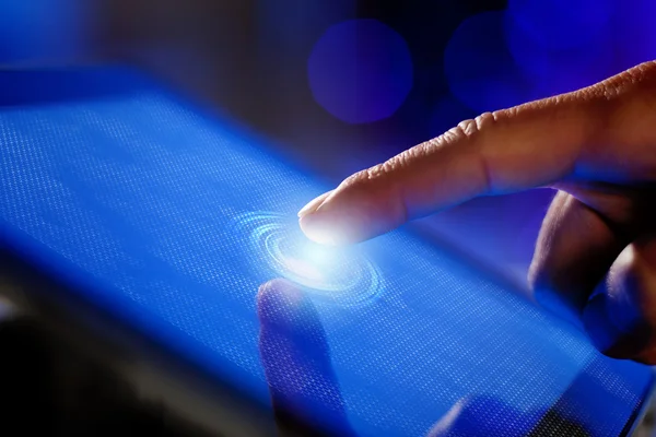 Closeup of finger touching tablet-pc screen — Stock Photo, Image