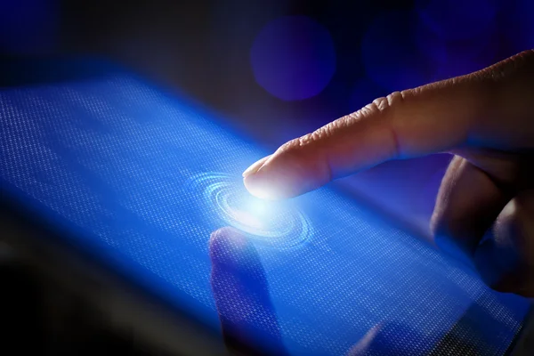 Closeup of finger touching tablet-pc screen — Stock Photo, Image