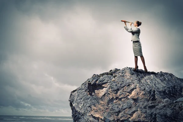 Business woman with telescope — Stock Photo, Image