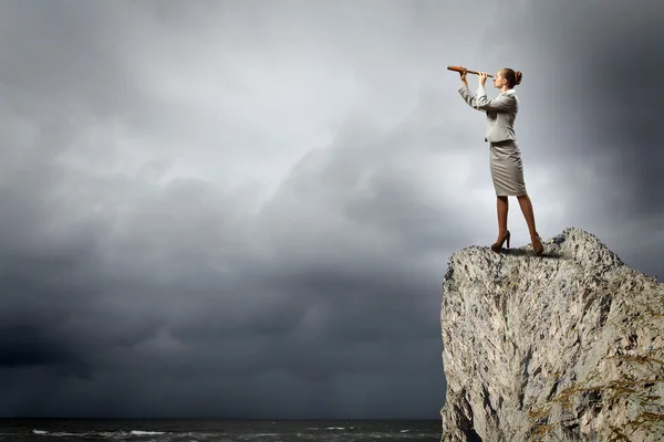 Business woman with telescope — Stock Photo, Image