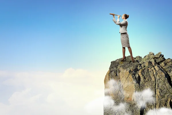 Business woman with telescope — Stock Photo, Image