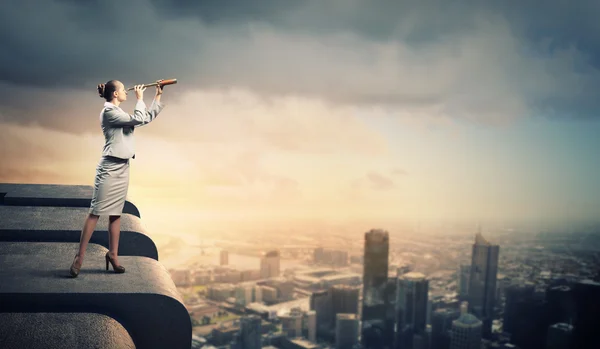 Business woman with telescope — Stock Photo, Image