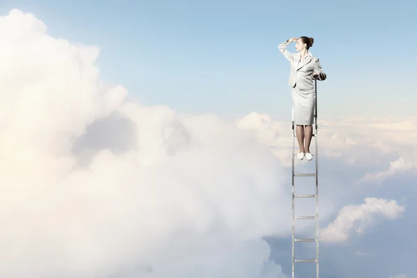 Businesswoman standing on ladder — Stock Photo, Image