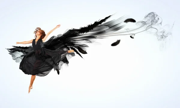 Woman floating on dark wings — Stock Photo, Image